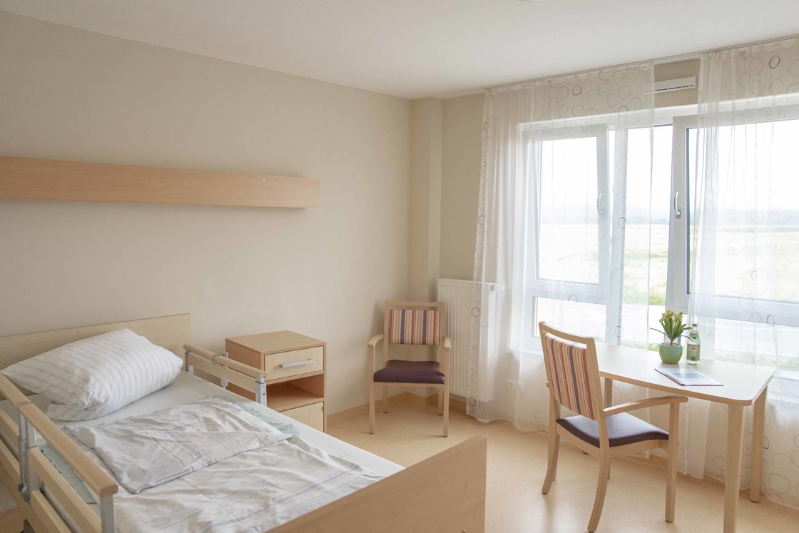 Leeres Zimmer - Ansicht Bett und Fensterfront