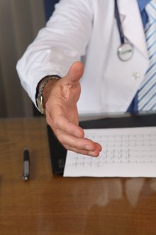Arzt streckt Hand aus, bietet Unterstützung bei Diätberatung im Krankenhaus an.